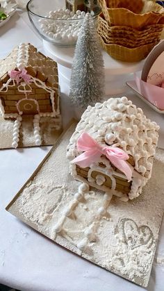 there are three cookies on the table with decorations around them and one cookie is shaped like a house