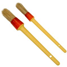 two yellow brushes with red tips on white background