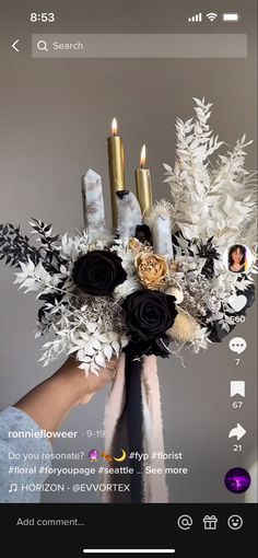 a person holding a bouquet with candles in it