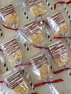 several bags of rice krispy treats wrapped in red and black ribbon