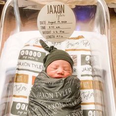 a newborn baby is wrapped in a blanket