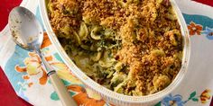 a casserole dish with broccoli, cheese and bread crumbs