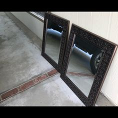 two mirrors sitting next to each other on the ground