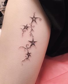 a woman's leg with stars on it and the word love written in black ink