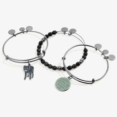 two bracelets with charms on them and one has a dog charm hanging from it