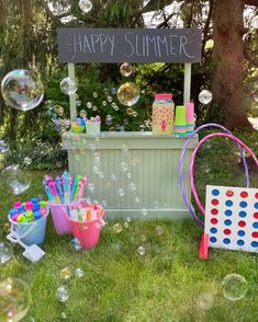 an ice cream stand with lots of bubbles in the air and a sign that says happy summer