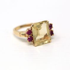 Breath-taking Retro era 14k yellow gold, created rubies, and genuine citrine ring, circa 1940s! This incredible cocktail ring showcases a 4.49 carat genuine citrine gemstone that is accented on each shoulder by two created rubies on each side. Phenomenal vintage statement ring, from the fashionable 40s! *Sale - price reduced from $850 USD to $840 USD.  ERA - Circa 1940s - Retro METAL / MATERIAL - 14k yellow gold, genuine citrine gemstone (approx. 4.49 cts), 4 created rubies (approx. weight unabl Rubies Jewelry, Retro Era, Logo Gifts, Citrine Ring, Ruby Jewelry, Citrine Gemstone, Cocktail Ring, Cocktail Rings, Statement Ring