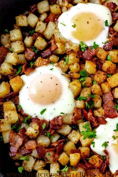 two fried eggs on top of potatoes in a skillet