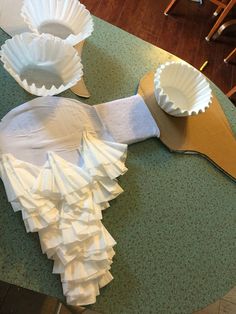 paper plates and cups are sitting on the counter top, ready to be made into an origami bird