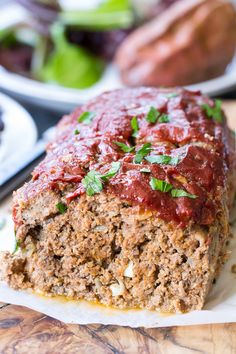 the meatloaf is covered with sauce and garnished with parsley