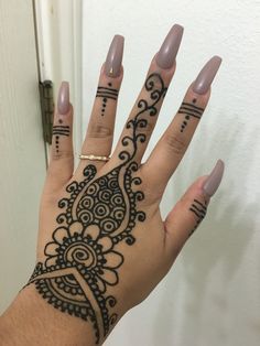 a person's hand with henna tattoos on it