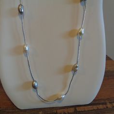 Hello. This Is A Beautiful Freshwater Pearl Station Necklace That I Got Many, Many Years Ago And Never Wore. This Is Not Sterling Silver. It Is 30" Long And Does Not Have A Clasp So It's A Put Over Your Head Necklace. The Freshwater Pearls Are Alternating With Natural Pearl Color And A Dove Gray Color. There Are 16 Pearls In All And Each Pearl Measures About 1/2" In Length And 1/4" In Width. This Varies A Bit Because They Are Natural. They Have Beautiful Luster, And The Silver Chain Is Bright. L Adjustable Silver Long Pearl Necklace, Adjustable Long Silver Pearl Necklace, Elegant Silver Single Strand Long Necklace, Adjustable Silver Pearl Necklace For Formal Occasions, Adjustable Silver Single Strand Pearl Necklace, Adjustable Single Strand Silver Pearl Necklace, Silver Metal Chain Necklace For Anniversary, Classic Silver Pearl Necklace With Silver Beads, Silver Adjustable Classic Pearl Necklace