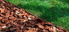 a pile of wood chips sitting in the grass