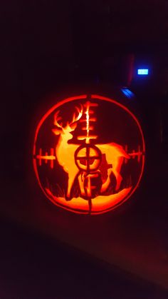 a carved pumpkin with an image of a deer on it's face in the dark