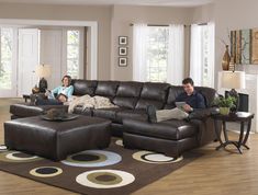 a man and woman sitting on a couch in a living room