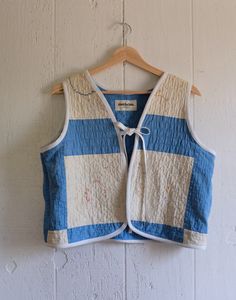 a blue and white vest hanging on a wall