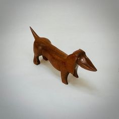 a wooden toy dachshund dog on a white background