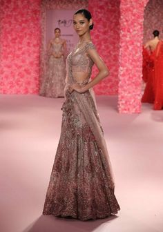 Make a grand entrance in this mauve pink shimmer tulle cocktail lehenga set. The lehenga’s heavy shimmer tulle creates a stunning, opulent effect, while its intricate crystal embellishments ensure a dazzling sparkle. The set includes a dupatta adorned with a 3d floral applique border, adding an elegant and textured touch. Heavily crystallized, this ensemble perfectly blends modern glamour with exquisite craftsmanship, making it an ideal choice for a memorable occasion. Pink Floor-length Evening Lehenga, Evening Floor-length Pink Lehenga, Pink Anarkali Lehenga For Evening, Floor-length Pink Choli For Evening, Pink Floor-length Evening Choli, Pink Sequined Lehenga For Evening, Pink Embellished Evening Lehenga, Evening Pink Sequins Lehenga, Pink Organza Lehenga For Evening