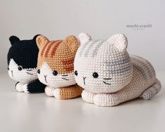 three crocheted cats sitting next to each other