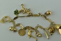 "Vintage 14K Yellow Gold Charm Bracelet, with 9K, 14K and 18K charms, largest charm 1\", 18K Yellow Gold, various charms, horns, marine life, chimney, sweeper, whistle, teapot, 7.5\" length, 15.3 grams Stock # BB205B06 This listing contains photographs of the actual item you will receive. Our items are in excellent condition with little or no signs of wear and many are one of a kind pre-owned estate finds. Please look closely at the pictures in this listing as they are part of the product descri Adjustable Gold Vintage Charm Bracelet, Adjustable Gold Charm Bracelet With Vintage Charm, Vintage Gold Charm Bracelet With Dangling Charms, Vintage Yellow Gold Charm Bracelet, Antique Charm Bracelet, Eyeshadow For Hooded Eyes, Hooded Eye Makeup Tutorial, Eye Makeup Application, Best Makeup Tutorials