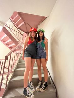 two young women standing on the stairs in front of an umbrella