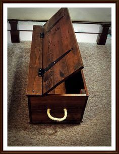 an open wooden box sitting on top of a carpeted floor next to a wall