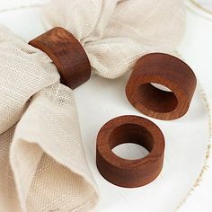 two pieces of wood sitting on top of a white cloth covered plate with napkins