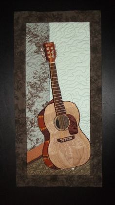 a painting of a guitar is hanging on the wall