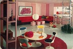 a living room filled with furniture and pink walls