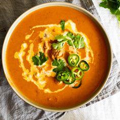 a bowl filled with soup and garnished with green peppers