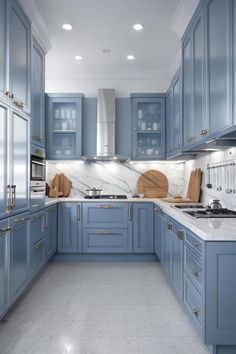 a kitchen with blue cabinets and marble counter tops