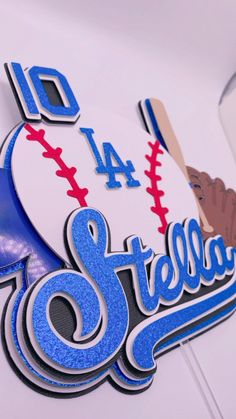 a close up of a sign with baseballs and bats on it's side