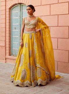 Editor's Note Hand Embroidered Lehenga Set With Placement Motifs And Zardosi Details Fabric: Organza Color: Honey Gold Care: Dry Clean Only About the Designer A melange of rich embroideries, ap... Gold Lehenga, Organza Embroidery, Organza Lehenga, Set Saree, Saree Gown, Embroidered Lehenga, Indian Fashion Designers, Bridal Lehenga, Aza Fashion