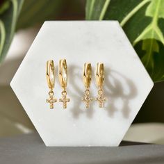 These Tiny Cross Gold Huggie earrings shimmer with every move. Minimal design made for those who are not too flashy. Great for those who have small earlobes. Perfect to wear on your secondary holes or cartilage for those with large earlobes. Gold Vermeil Hypoallergenic, lead and nickel free Hoop Inside Diameter 7mm, Thickness 1.8mm Cross Height: 7mm Hinge Closure Handmade in NYC #E587-G Adjustable Hypoallergenic Huggie Earrings, Hypoallergenic Dangle Piercings For Everyday, Dainty Huggie Hypoallergenic Earrings, Huggie Earrings Gold, Tiny Cross, Ear Stack, Small Crosses, Cross Earrings, Dainty Earrings