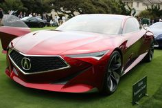 the concept car is on display in front of other cars at an event with people standing around