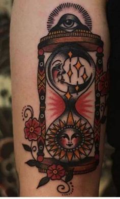 a tattoo on the leg of a woman with an hour clock and sunflowers