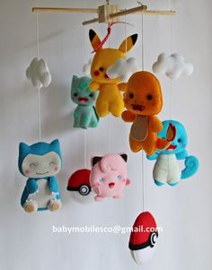 several stuffed animals hanging from a mobile in a child's room or playroom