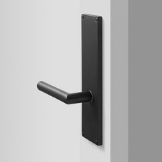 a black door handle on a white wall