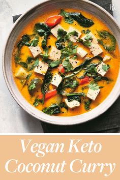 vegan keto coconut curry with tofu and spinach in a white bowl