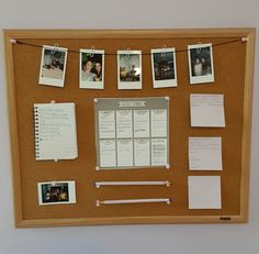 a cork board with pictures and memos on it in front of a white wall