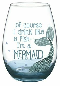 a wine glass with an image of a mermaid on the bottom and words that say i drink like a fish, i'm a mermaid