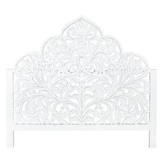 a white headboard with an intricate design