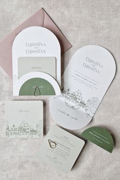 the wedding stationery is laid out on top of each other