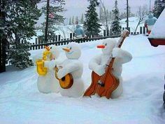 two snowmen are playing music in the snow