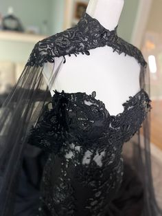 a black wedding dress on display in a store