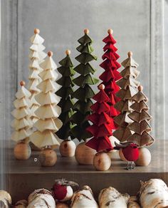 small wooden christmas trees lined up on top of each other in different colors and sizes