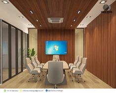 an empty conference room with chairs and a flat screen tv on the wall above it