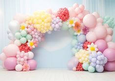 an arch made out of balloons and flowers