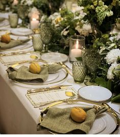 the table is set with plates and place settings