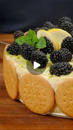 a cake with blackberries and lemons on top